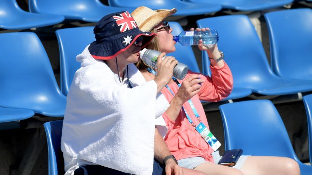 Tennis goers do their best to keep cool.