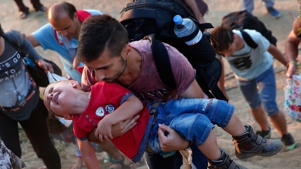 Syrian refugees walk to a crossing on the Greek and Macedonian border. 