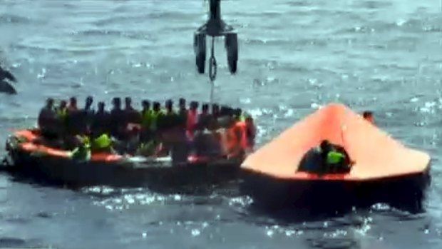 Survivors aboard a life raft after their boat capsized.