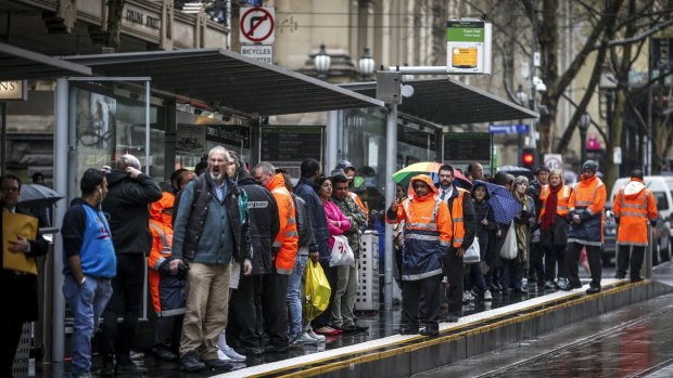 Passengers wait at a tram stop ahead of the most recent tram strike on August 27. 