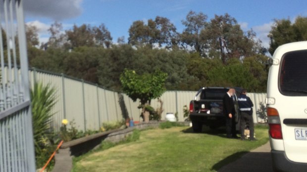 An AFP officer at the raided house.