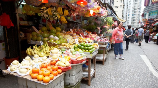 A fruit and vegetable stand in a market in Kowloon.
