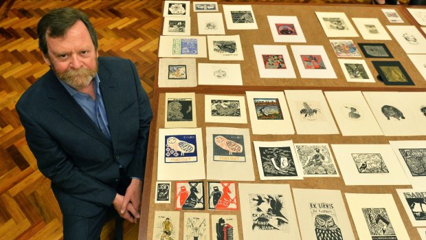 Robert Littlewood with some of the bookplates included in the exhibition.