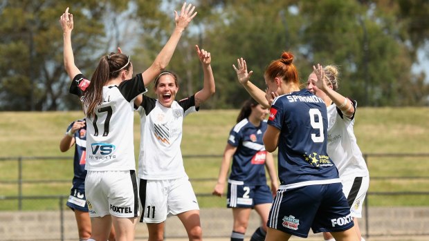 Adelaide United's Tiarn Powell celebrates after kicking a goal against Melbourne Victory at Epping Stadium. 