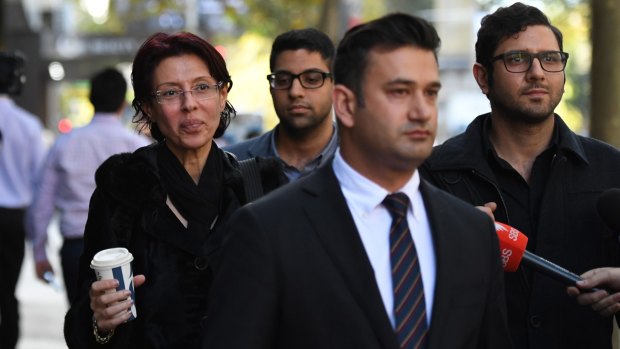 Eman Sharobeem, left, outside the corruption hearing with sons Charlie, right, and Richard, rear. Lawyer Arjun Chhabra is in front.