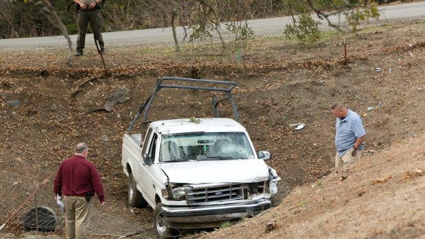 Investigators view a pickup truck involved in the deadly shooting rampage at the Rancho Tehama Reserve.