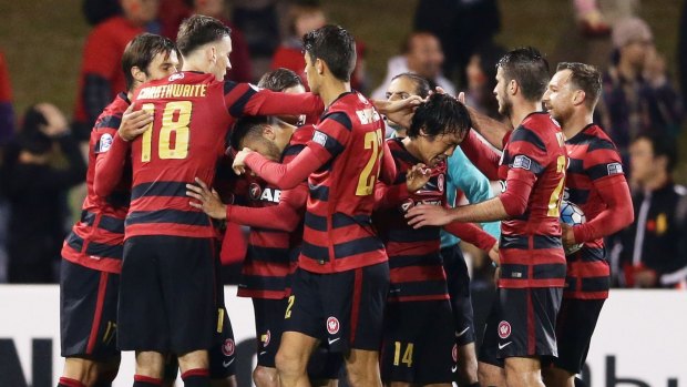 Going out in style: Jumpei Kusukami and the Wanderers celebrate.
