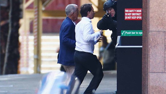 John O'Brien and Stefan Balafoutis flee from the Lindt cafe during the siege.