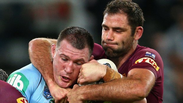 Hold on there: Paul Gallen of the Blues is tackled by Maroons captain Cameron Smith during Origin III.