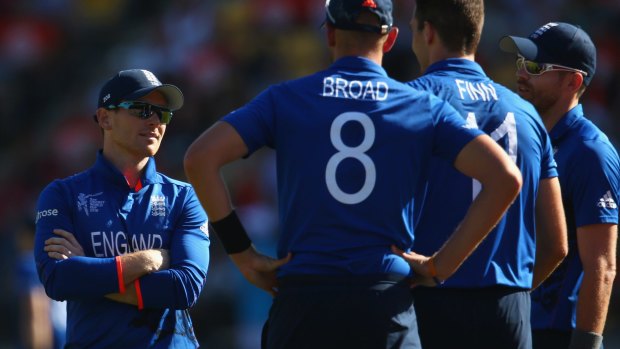 All talk, little action:  England captain Eoin Morgan speaks to his bowlers Stuart Broad, Steven Finn and James Anderson during Friday's embarrassing loss.