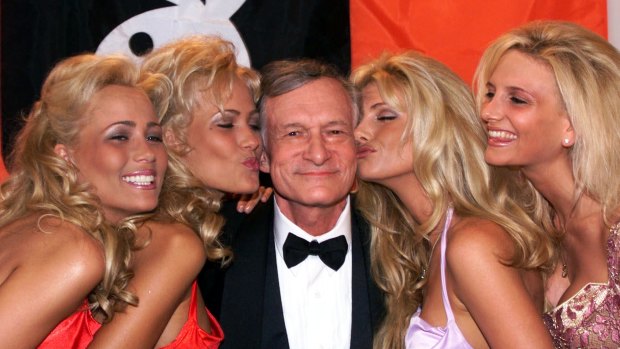Playboy founder and editor in chief Hugh Hefner receives kisses from Playboy playmates during the 52nd Cannes Film Festival in Cannes, France in 1999.