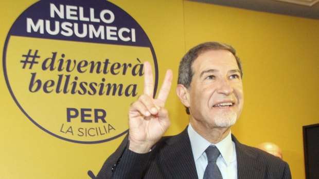 Centre-right coalition candidate Nello Musumeci flashes a victory sign after winning the regional elections in Palermo, Sicily.