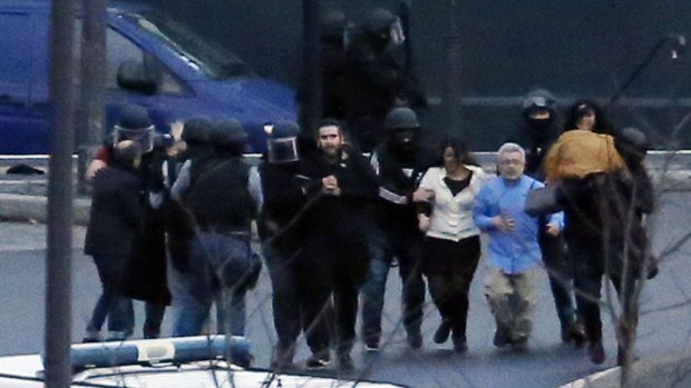 Members of the French police special forces evacuate the hostages after launching the assault at a kosher grocery store.