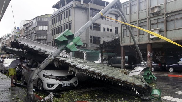 A car is crushed by a fallen roof.