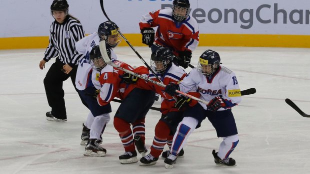 South, wearing white, and North Korean players, in red, compete during a women's ice hockey world championship game last month.