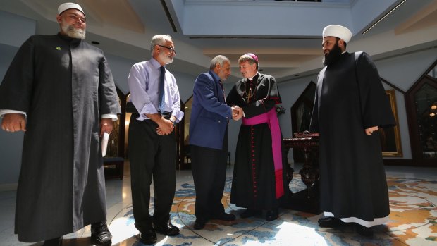 Catholic Archbishop of Sydney Most Rev, Anthony Fisher and Grand Mufti Dr Ibrahim Abu Mohammad of the Australian National Imams Council shake hands. 
