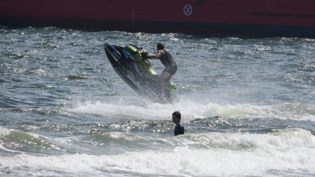 A jet-skier at Port Melbourne beach gets a bit close to a swimmer.