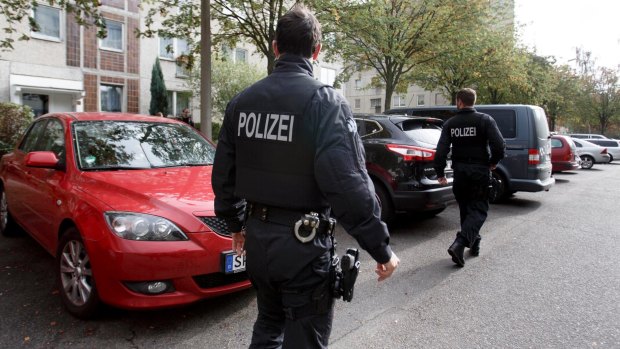 German police outside the suspect's apartment building.