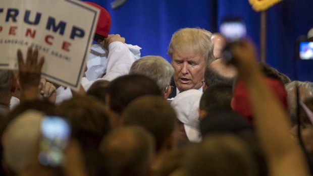 Donald Trump, swamped by fans at the conclusion of a campaign event in Phoenix.