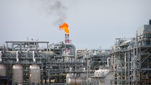 A flame blazes on top of flare stacks at a plant at the Queensland Curtis Liquefied Natural Gas Project.
