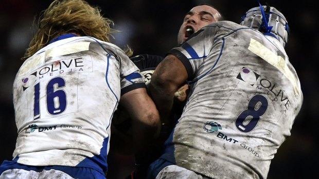 Crunched: Toulouse scrum-half Jean-Marc Doussain is hit by Bath's hooker Ross Batty (L) and flanker Leroy Houston.