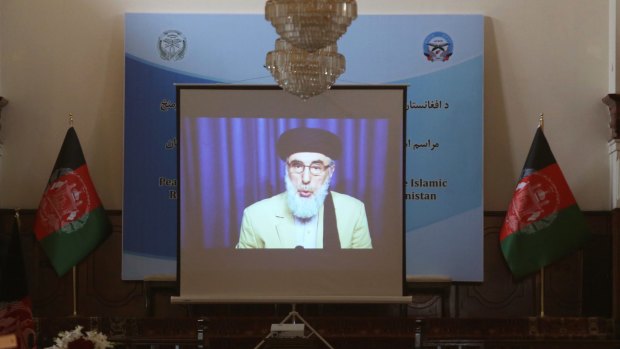 A screen shows live broadcast of Gulbuddin Hekmatyar during the signing  of a peace treaty between his faction and the government at the presidential palace in Kabul in September.