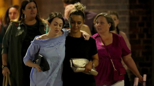 Shocked concert goers leave Manchester Arena after the blast.