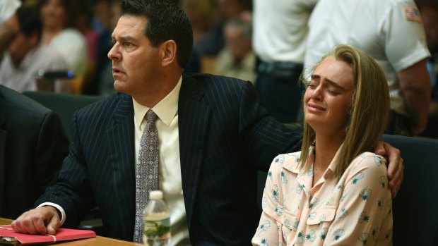 Michelle Carter, seated beside her attorney Joseph Cataldo, reacts as Judge Lawrence Moniz finds her guilty of involuntary manslaughter.