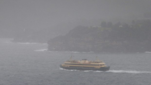 A barely visible Manly ferry makes its way from the city.