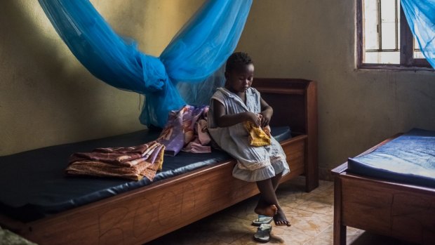 Sweetie Sweetie, an Ebola orphan, sits in her bedroom at a group home in Port Loko, Sierra Leone.