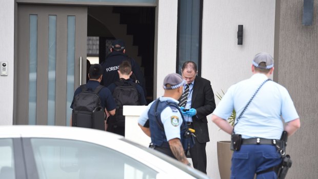 Police raid a house in Merrylands.