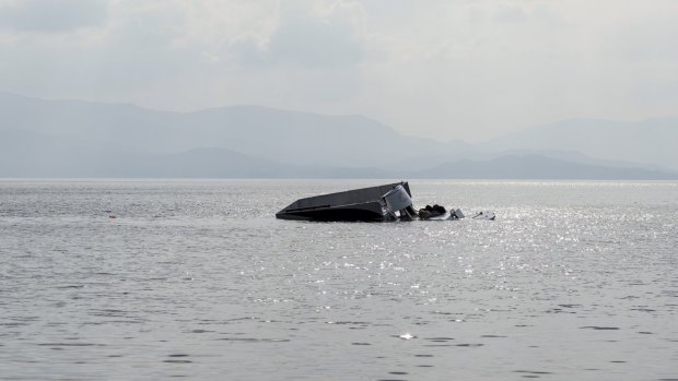 The remains of the boat that was carrying migrants seen off the shore near the Aegean town of Ayvacik, Turkey on Saturday.