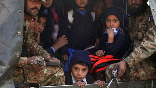 Pakistani soldiers transport rescued school children from the site of an attack by Taliban.