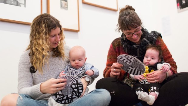 Katie Dixon, with baby Archie, and Catherine Hemingway, with baby Art, show them black and white patterns.
