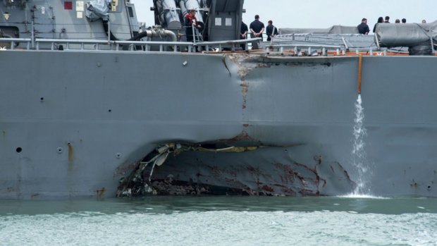 Damage to the portside is visible as the Guided-missile destroyer USS John S. McCain steers towards Changi naval base in Singapore following a collision with the merchant vessel Alnic MC.