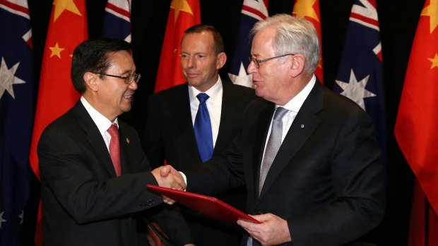 Chinese Commerce Minister Gao Hucheng, former prime minister Tony Abbott and Trade Minister Andrew Robb at the signing of China-Australia free trade agreement in June. 