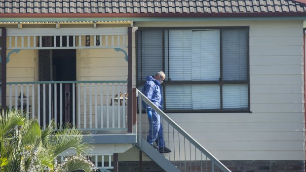 Forensic officers search the Bundeena home where Ms Kontozis died. 