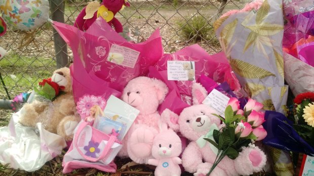 Tributes for Sanaya are lined up along a fence.