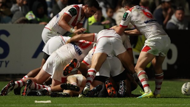 Aitken's teammates mob him after his match winner. 