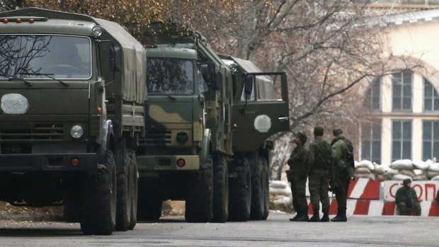 On the move: A convoy of unidentified military trucks stops near a checkpoint  in Donetsk.