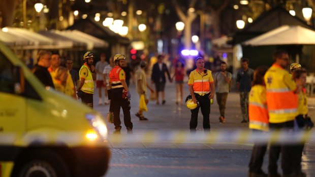 Emergency workers stand on a blocked street in Barcelona, Spain after an IS-linked terror attack.