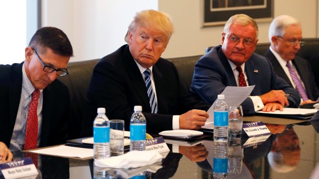 Donald Trump participates in a roundtable discussion on national security last year with retired army general Michael Flynn, left, and senator Jeff Sessions, far right. 