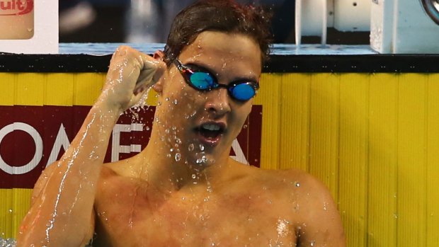 Mitch Larkin celebrates after winning the men's 100m backstroke during the World Swimming Championships in Doha. 