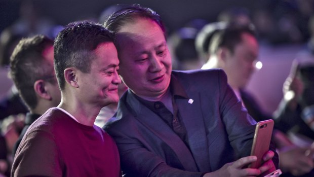 Billionaire Jack Ma, chairman of Alibaba Group (left) smiles for a photograph at the launch of the Singles' Day shopping event.