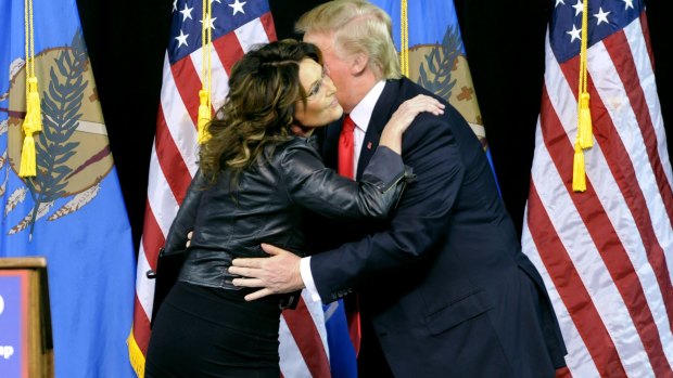 Former Republican vice-presidential candidate Sarah Palin hugs Republican presidential candidate Donald Trump at a rally in Tulsa, Oklahoma.