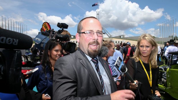 Media attempt to question Senator Ricky Muir outside Parliament House on Tuesday.
