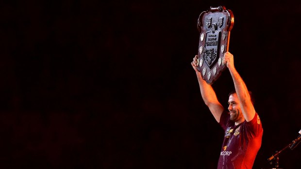 Cameron Smith of the Maroons holds up the winners' shield.