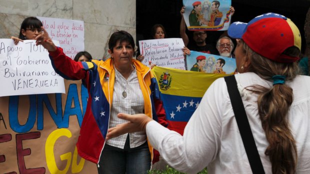 Duelling demonstrators gather outside Venezuela's embassy in Mexico City.
