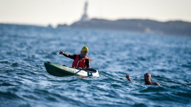 Swimmer Grant Siedle swims the 'Rip', with friend Eugene Docherty in the kayak.