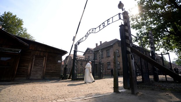 Pope Francis walks through the infamous gates of Auschwitz.